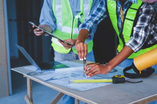 Group of multi ethnic engineer construction site worker meeting at workplace, Architects working together at construction site to remodeling home or building. Working with laptop and tablet pc