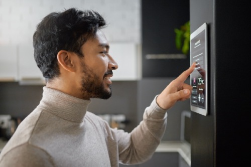 Smart home technology, wall system and man with digital ui monitor for thermostat heating, safety security network or air conditioning. AI software app, house automation or profile of person with IOT