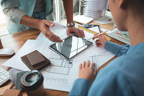 2 persons reviewing tablet and building planes.