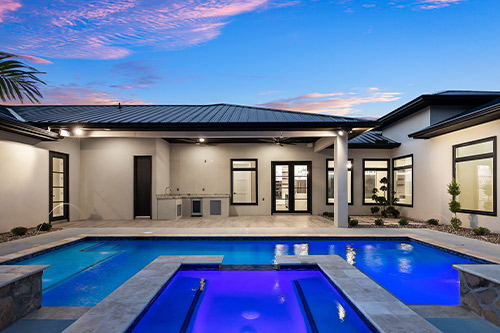 modern backyard pool with leds at sunset. 