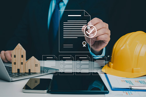 Builder reviewing legal papers and contracts. 