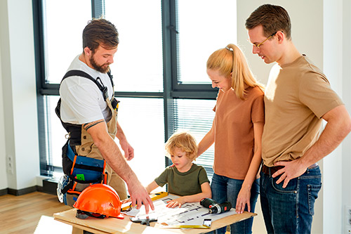 A family collaborates on a construction project, showcasing teamwork and shared effort in McAllen.